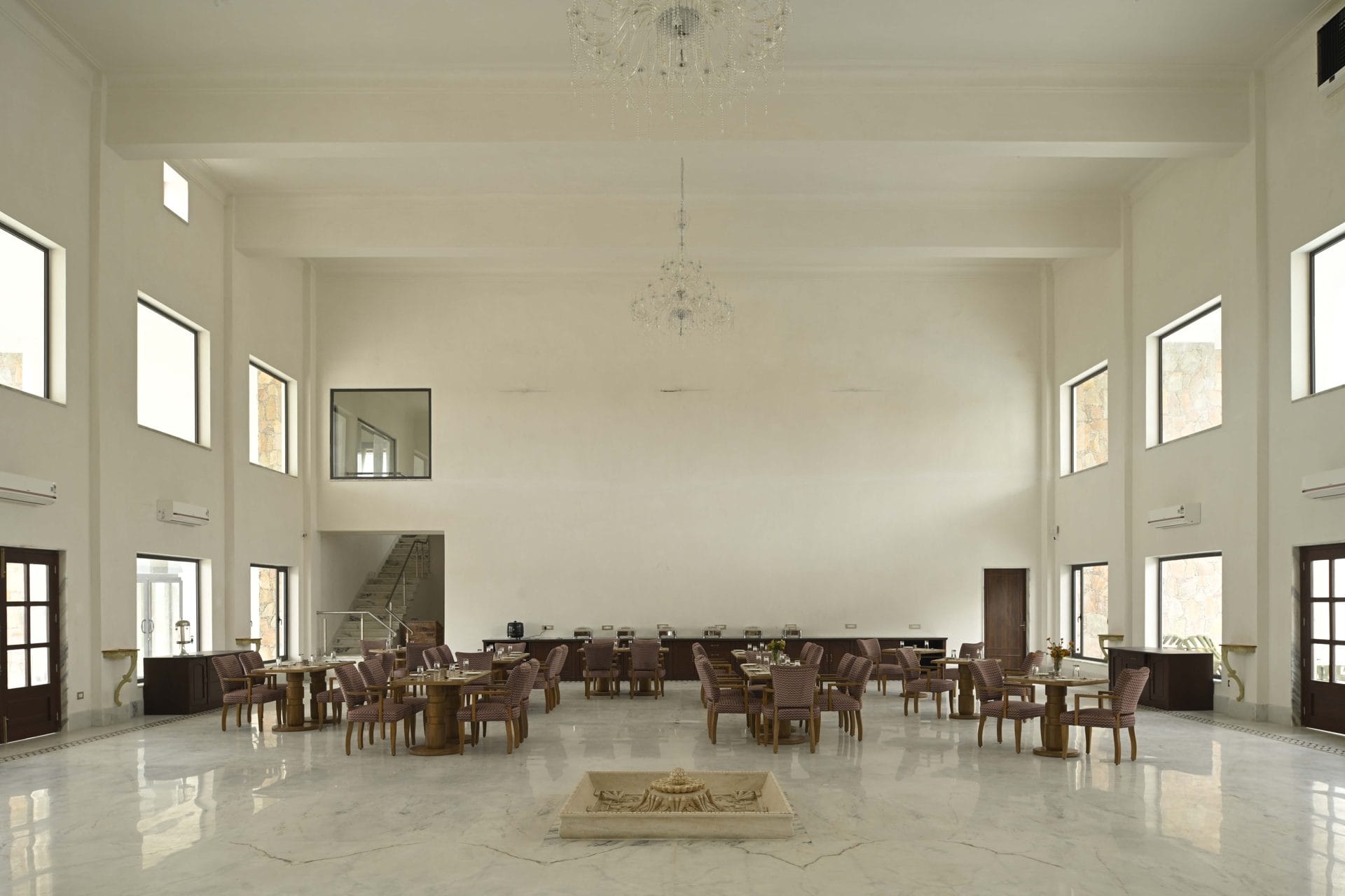 Wide view of the dining hall with 2 chandeliers and buffet counters
