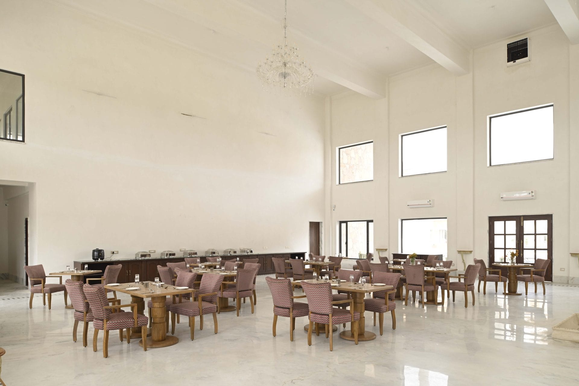 Dining tables set beside buffet counters in the evening