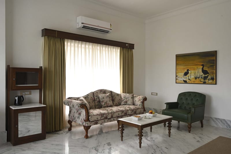 Suite living room with sofa, tea and coffee cabinet, and framed art