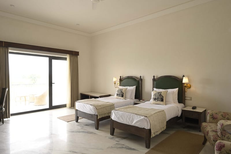 Twin Bed Room beds facing the balcony door with daylight on the marble floor