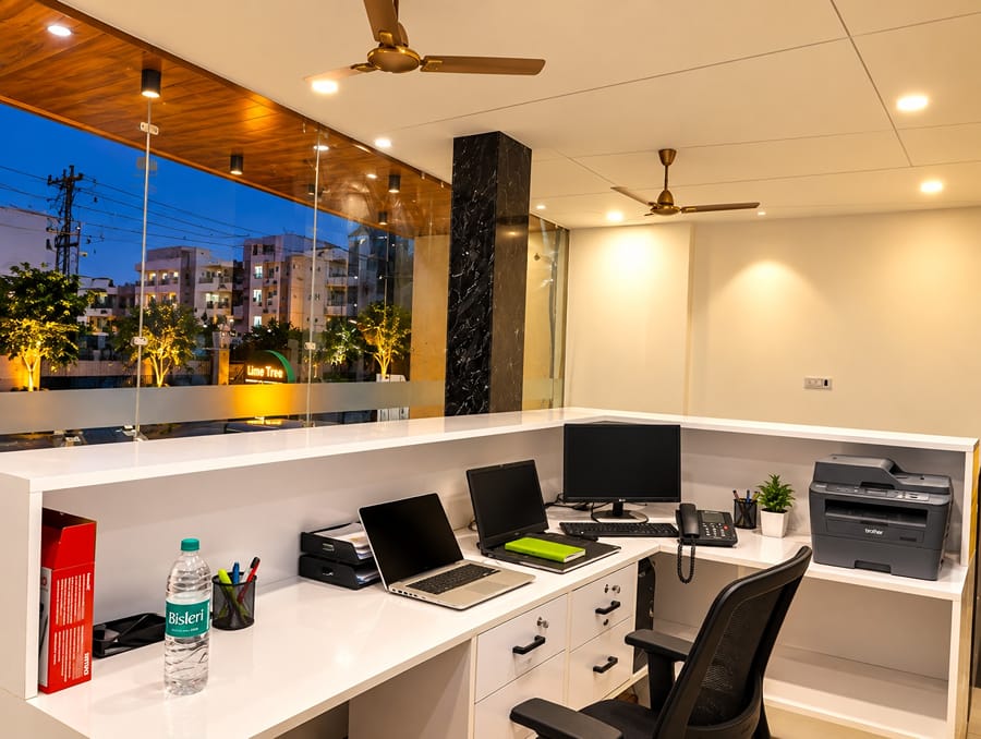Front office workstation with laptops and a printer at Lime Tree Hotel, Vrindavan