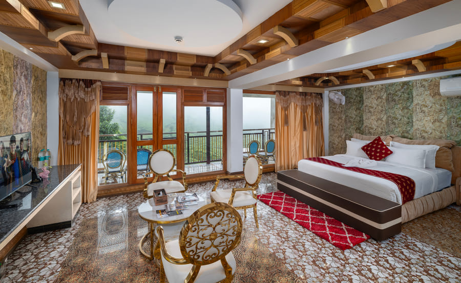 Opulent Presidential Suite at Parakkat Nature Resort Munnar featuring expansive wrap-around mountain balconies, marble living salon, master bedroom overlooking endless tea hills