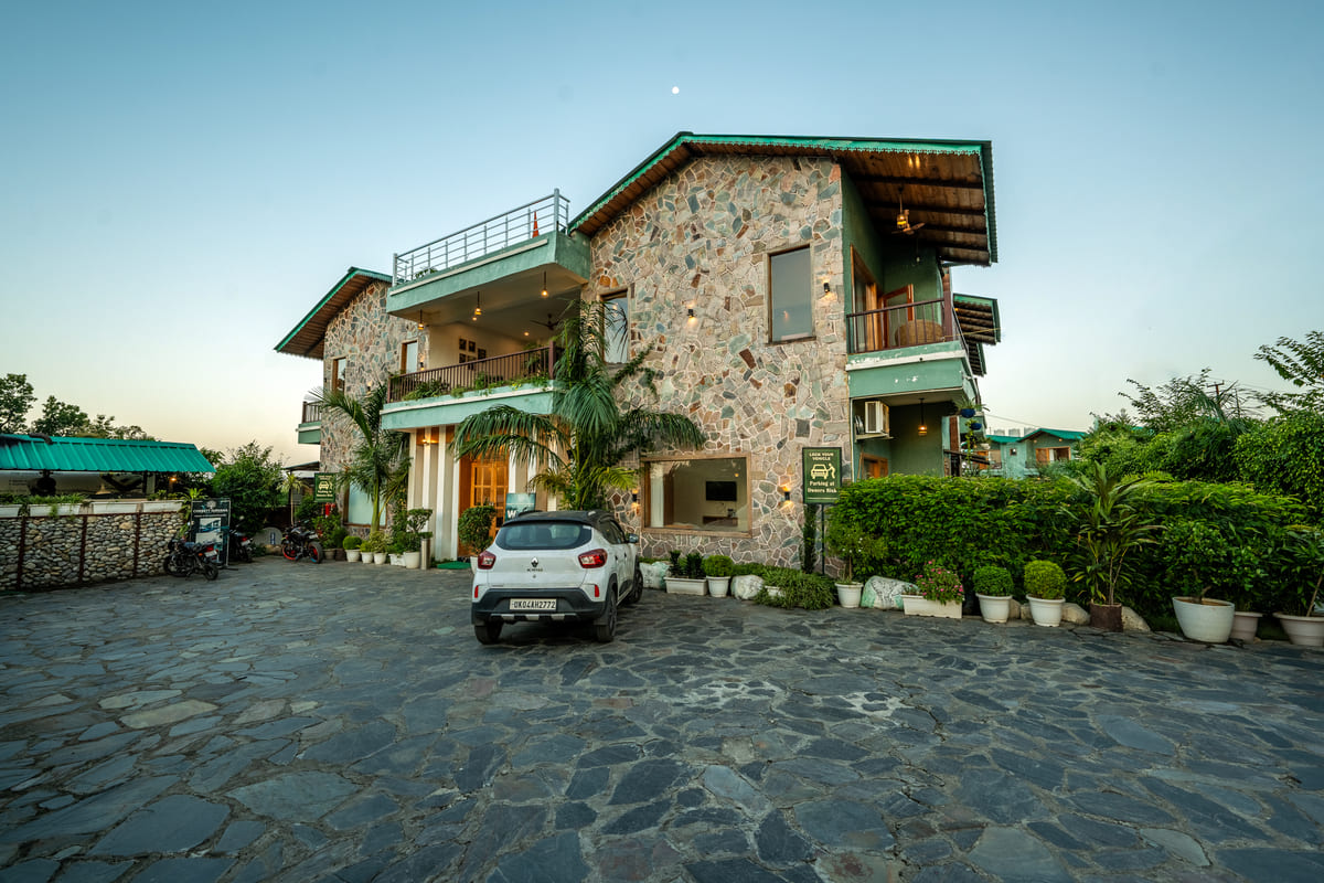 Facade and lawn at Corbett Nirvana Resort