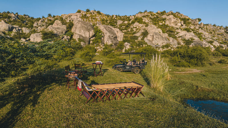 A long table set among the boulders, seen from above