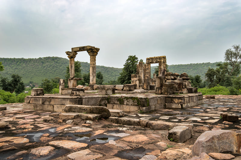 Carved stone pillars and ruined shrines at Neelkanth Mahadev