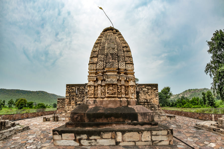 Carved stone temple at Neelkanth standing in a forest clearing