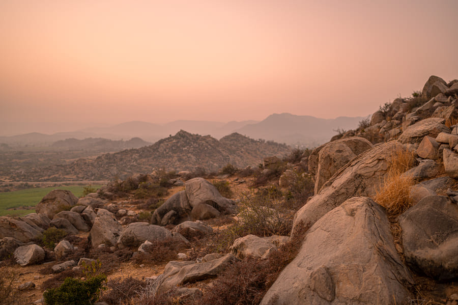 Granite boulders scattered across the Aravalli hills at dusk