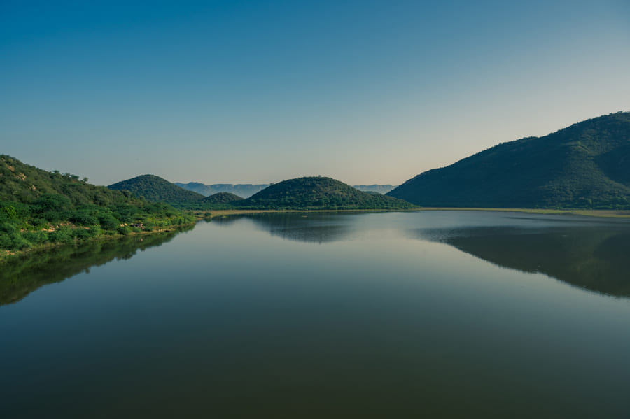 A still waterbody held between the Aravalli hills