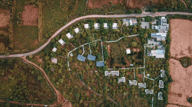 An aerial view of the village, its fields and the road running through
