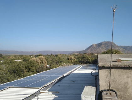 Solar panels on the camp roof, hills beyond