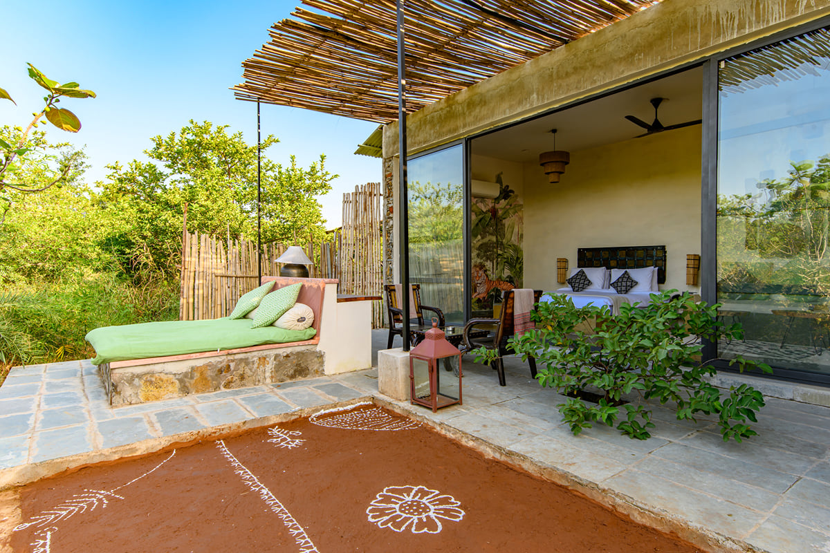A private patio with a cushioned daybed outside a guest room