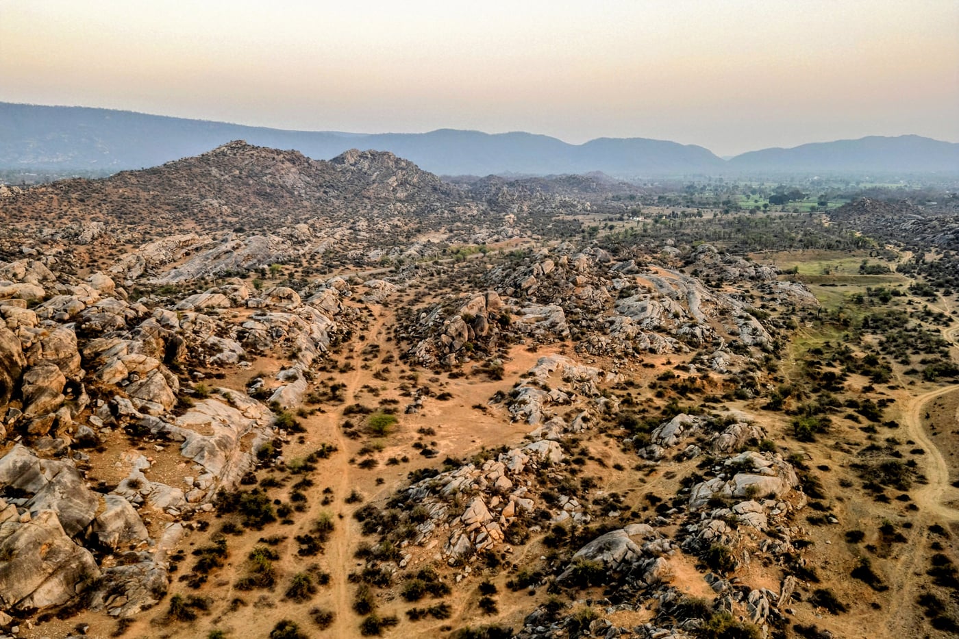 Boulder-strewn hills rolling away across the reserve, seen from the air