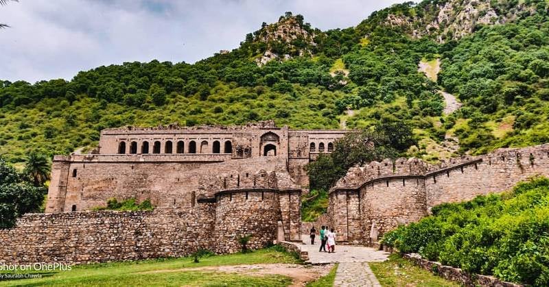 Bhangarh fort- a historic hilltop fortress, viewed from a distance.