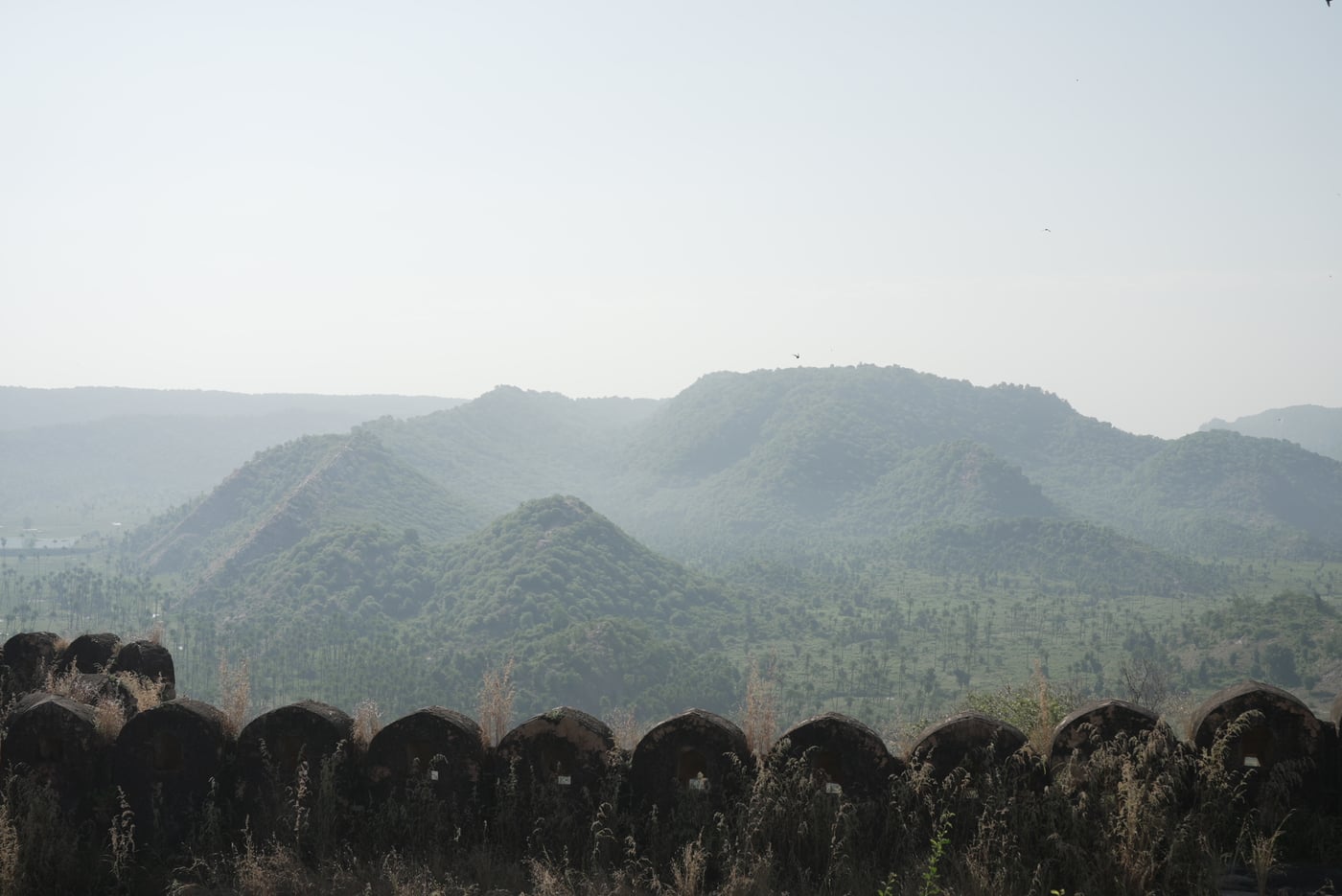 Overview of scenic mountains covered in mist | Utsav Camp Sariska