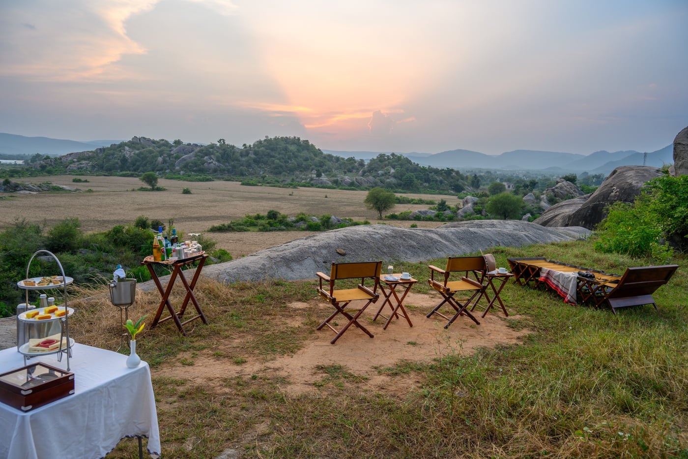 A seating arrangement made with a serene sunset in the background - Utsav Camp Sariska.