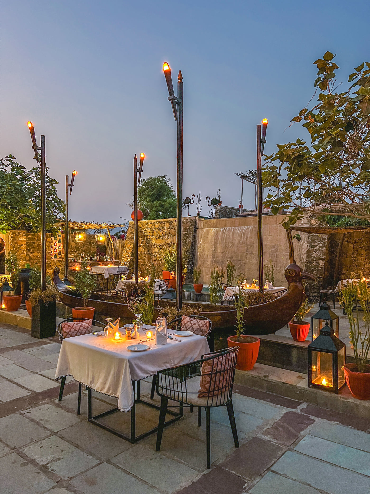An image of an outdoor seating at the hotel with decorative lighting - Utsav Camp Sariska
