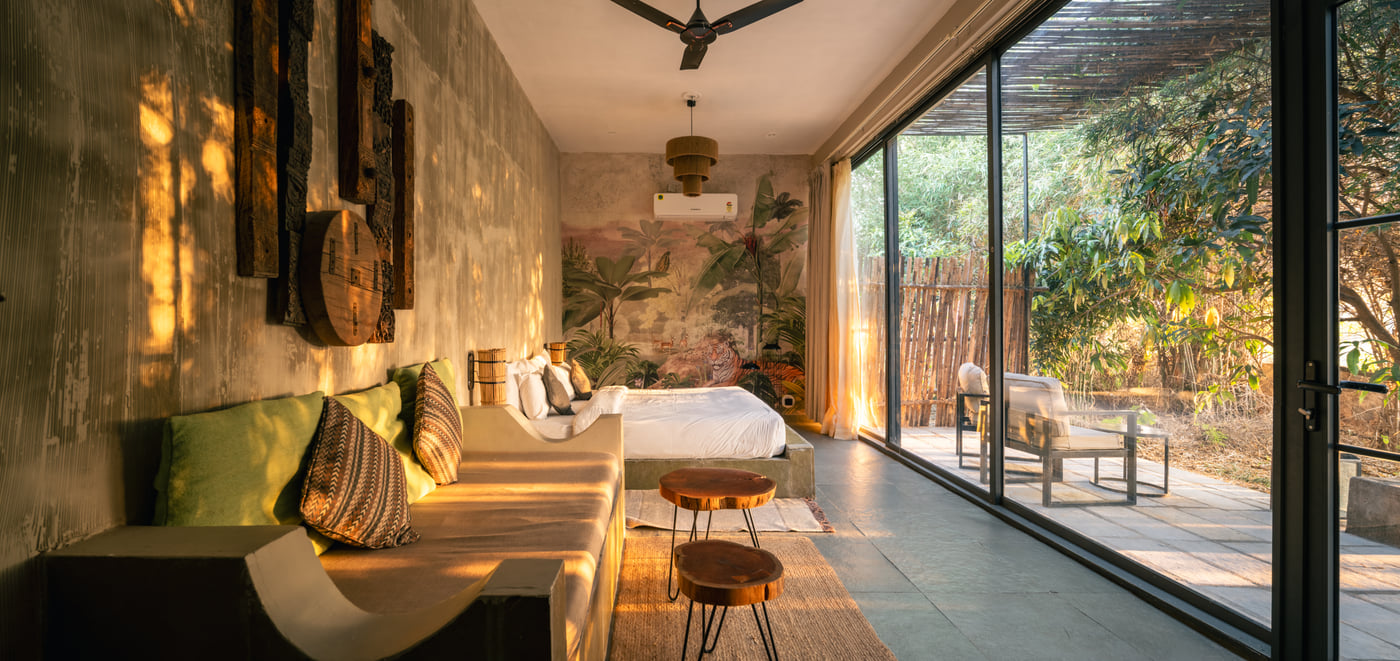 A Stone Cabin interior with cushioned seating and glass doors onto a private patio