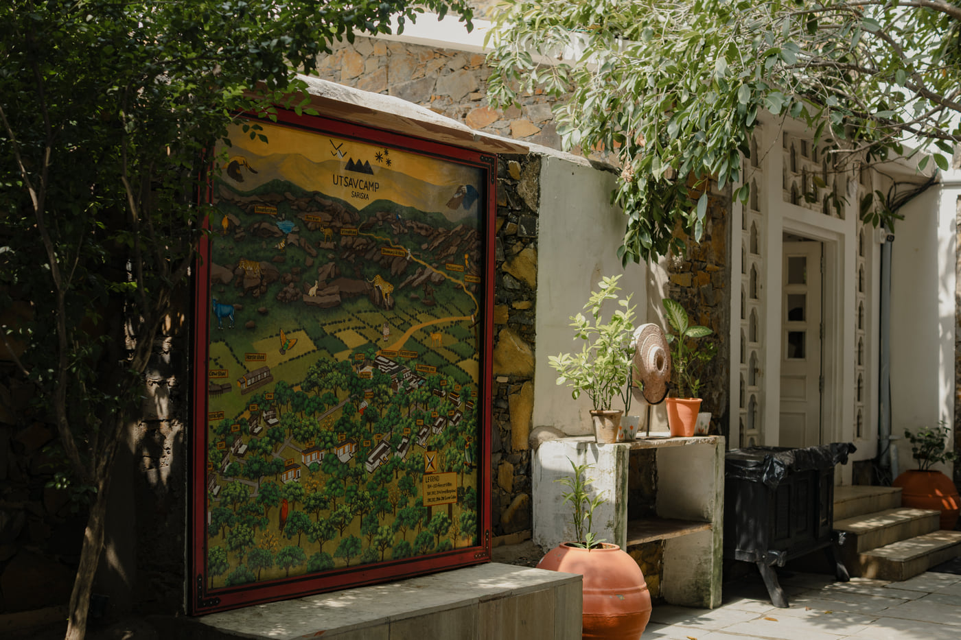 Hand-painted naturalist map at Utsav Camp Sariska displayed outdoors near the entrance.