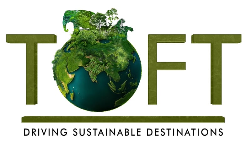 A logo of TOFTigers which is a driving sustainable destination. The Logo has an earth with most part covered in green grass and the animal silhouette is also made of green grass.