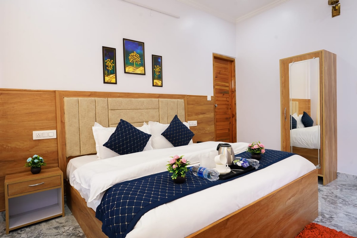 Deluxe Room at Hotel Sparrow Dharamshala — king bed with city-facing balcony