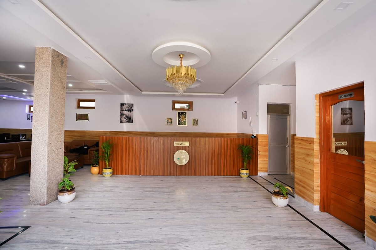 Reception desk at Hotel Sparrow Dharamshala — front-desk under chandelier