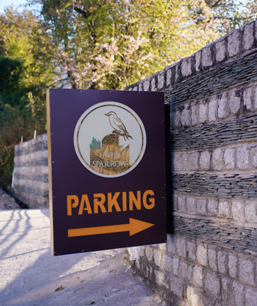 Hotel Sparrow Dharamshala on-site signage on a slate-stone wall