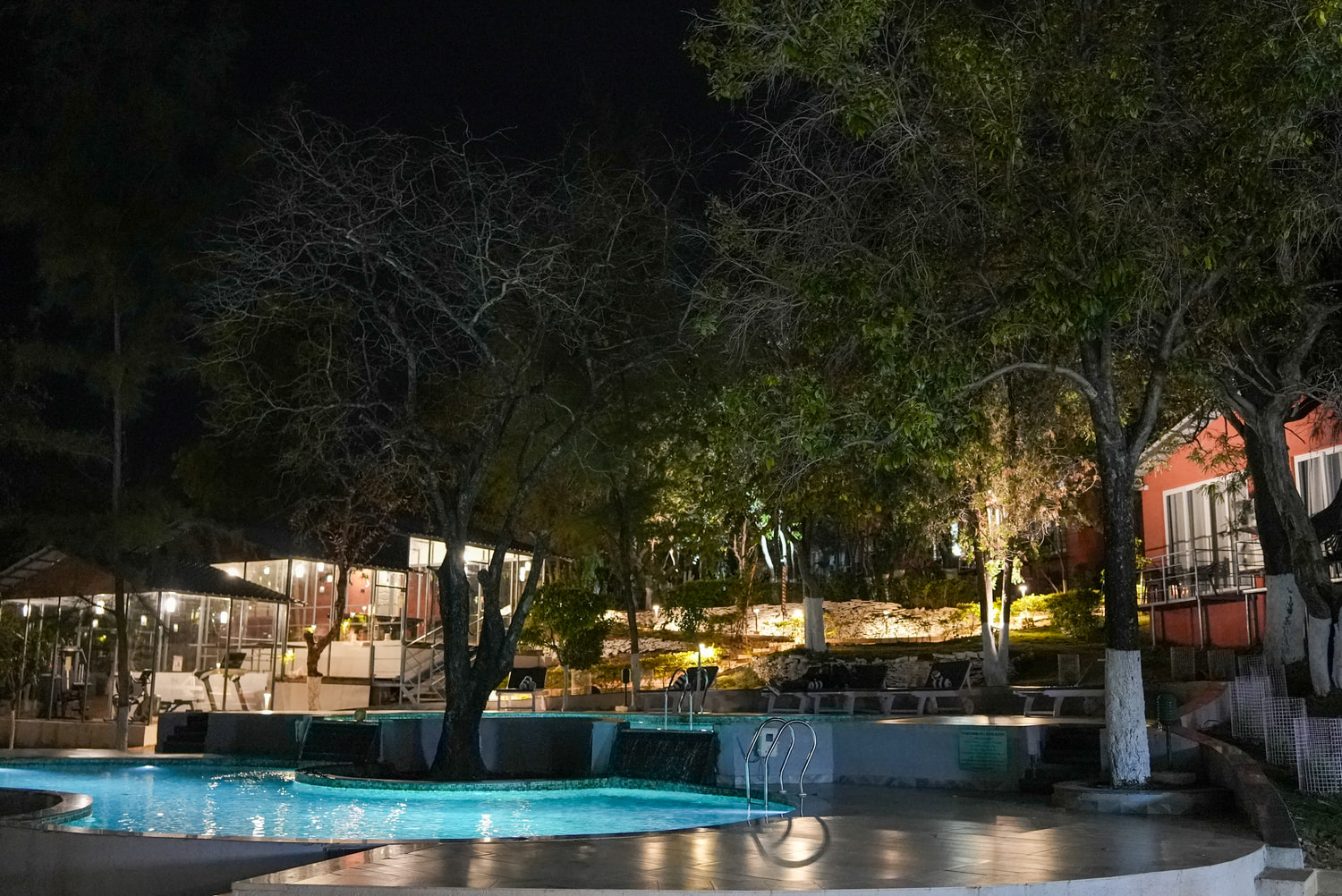 The swimming pool at night at Citrus Prime Hill Queen Resort, Pachmarhi