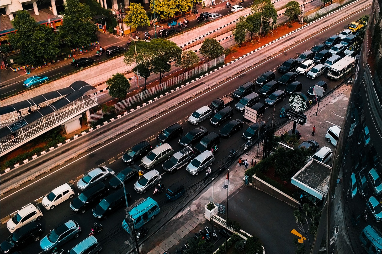 Busy multi-lane road lined with office buildings seen from above