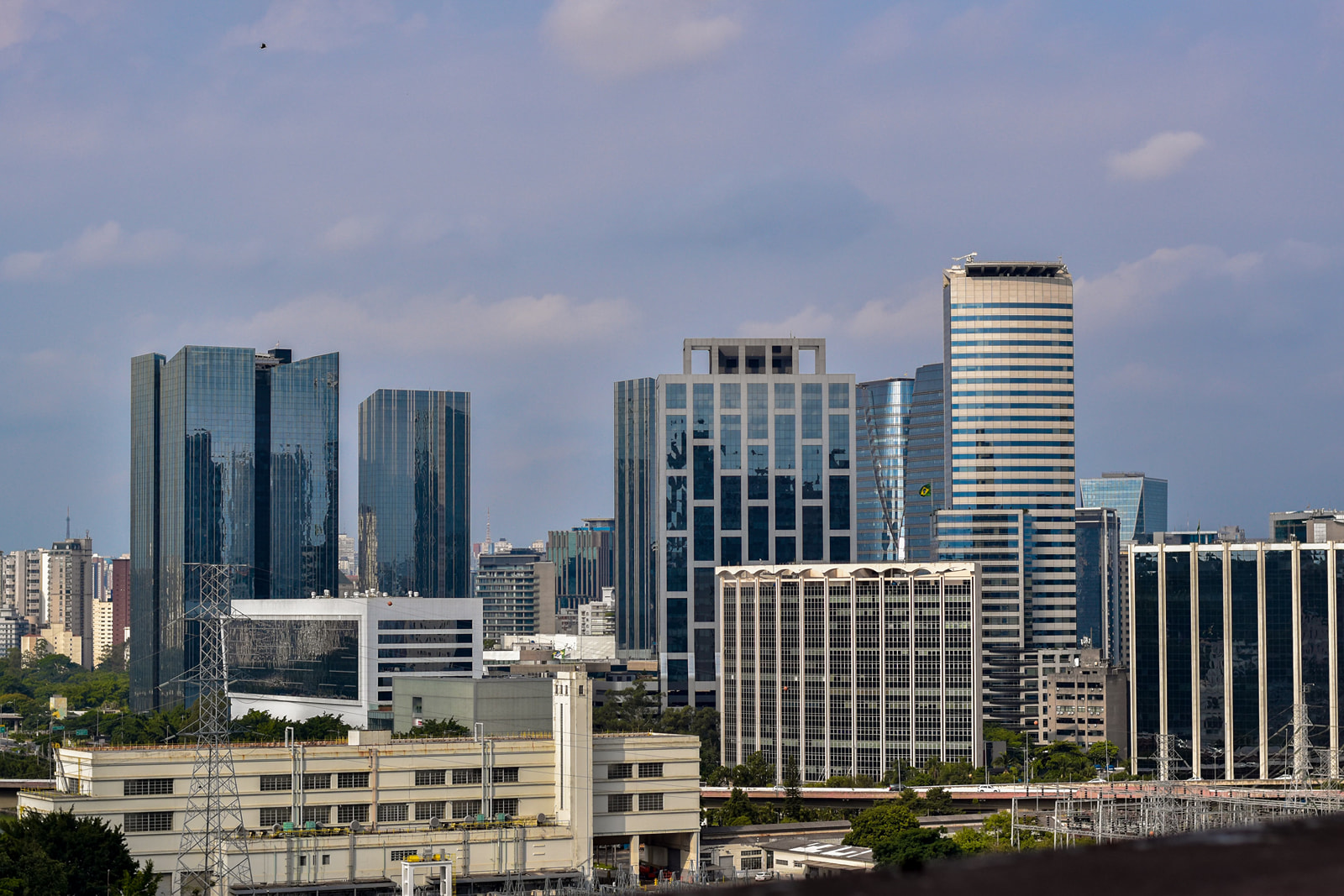 Glass office towers rising above low-rise buildings in an IT business district