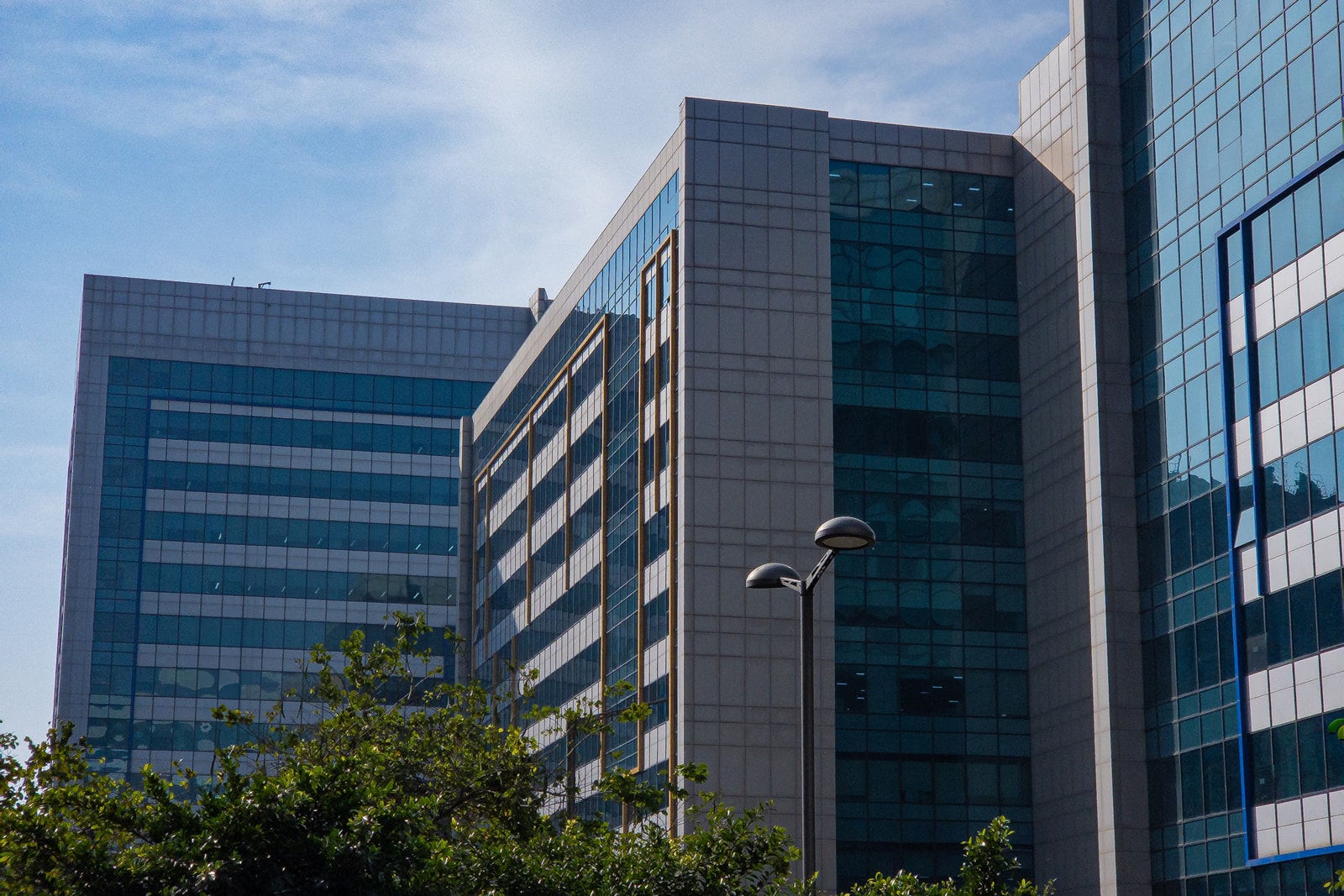 Modern glass office blocks with a street lamp in the foreground