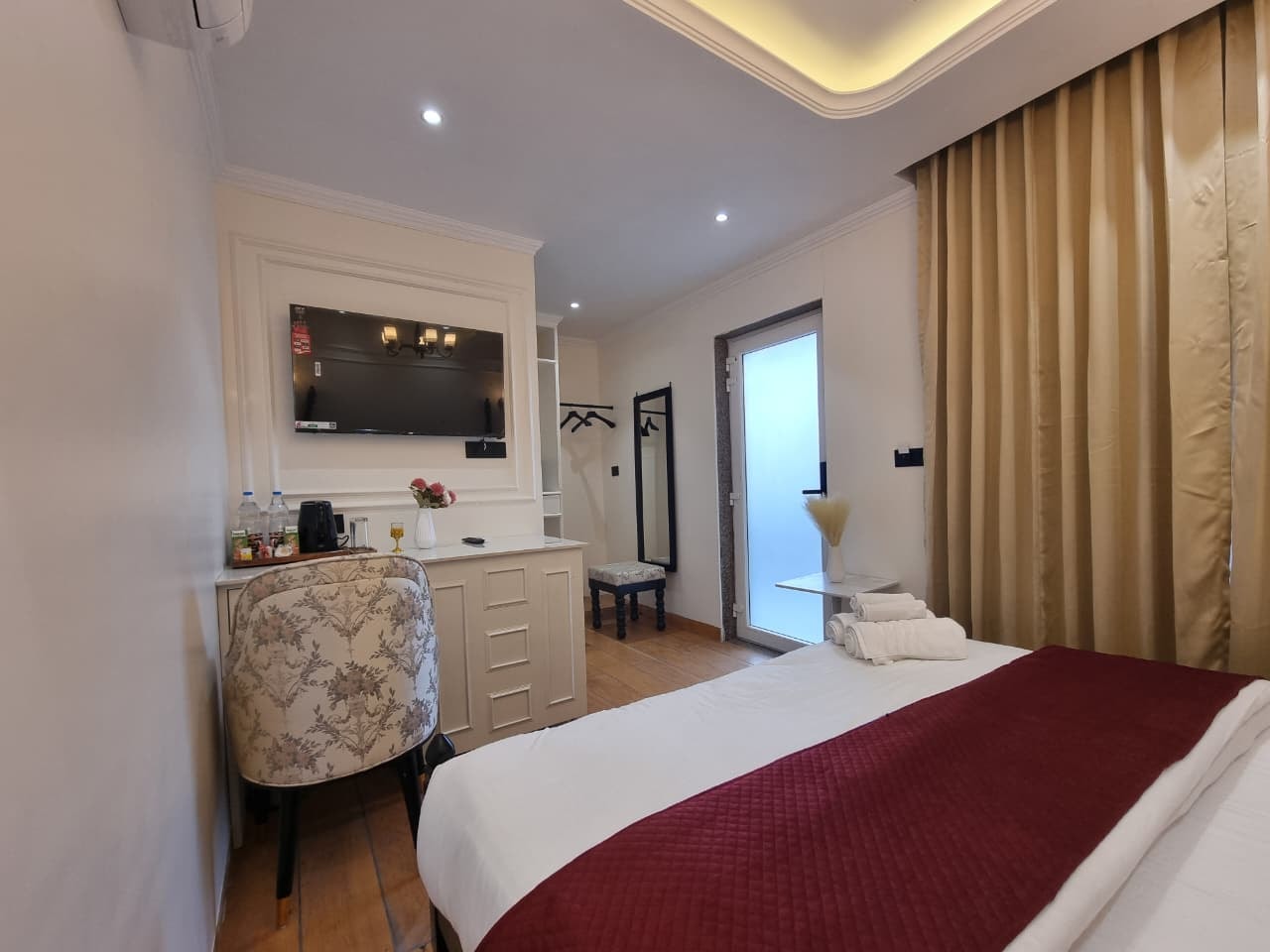 Elegantly furnished king bedroom with chandelier and warm ambient lighting at Akasa Dalhousie