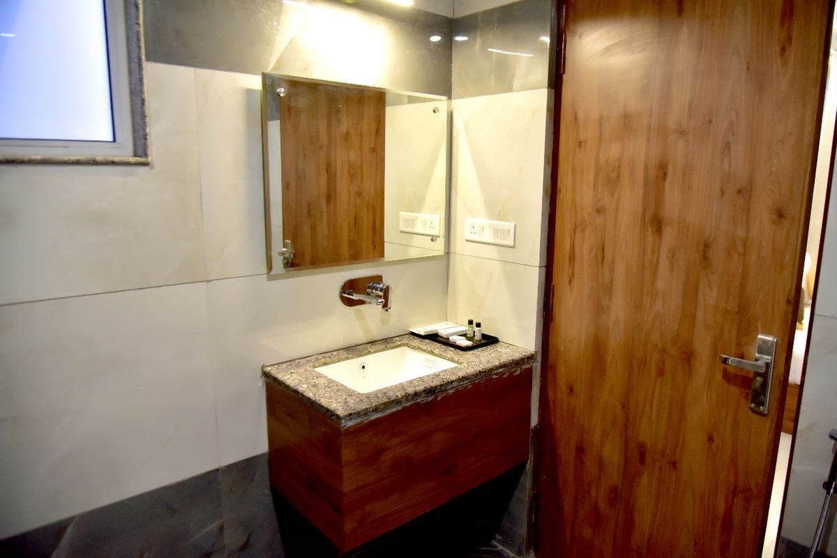A room bathroom at Hotel Aarna Premier, Jaipur
