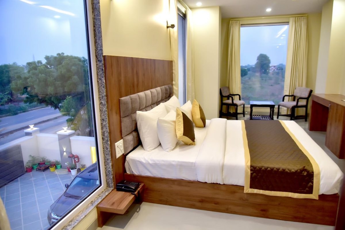 A bright corner room at Hotel Aarna Premier, Jaipur