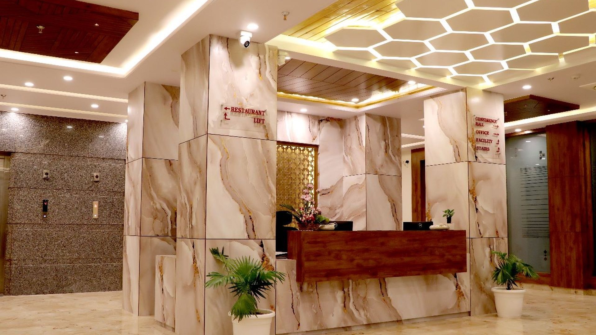 Reception with a backlit honeycomb ceiling at Hotel Aarna Premier, Jaipur