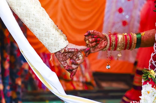 Bride and groom’s henna-adorned hands joined during the wedding rituals at Hotel Aarna Premier, Jaipur