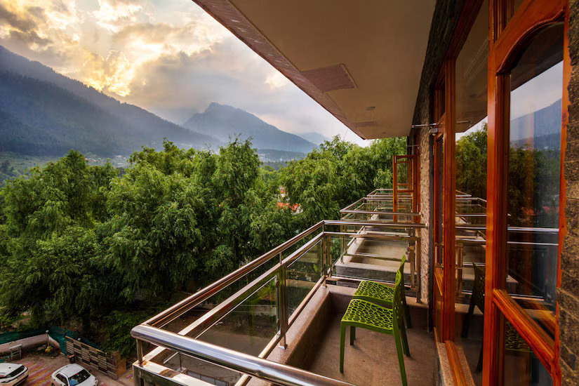 Manali mountain sunset view from a private balcony at Hotel Suryansh Regency