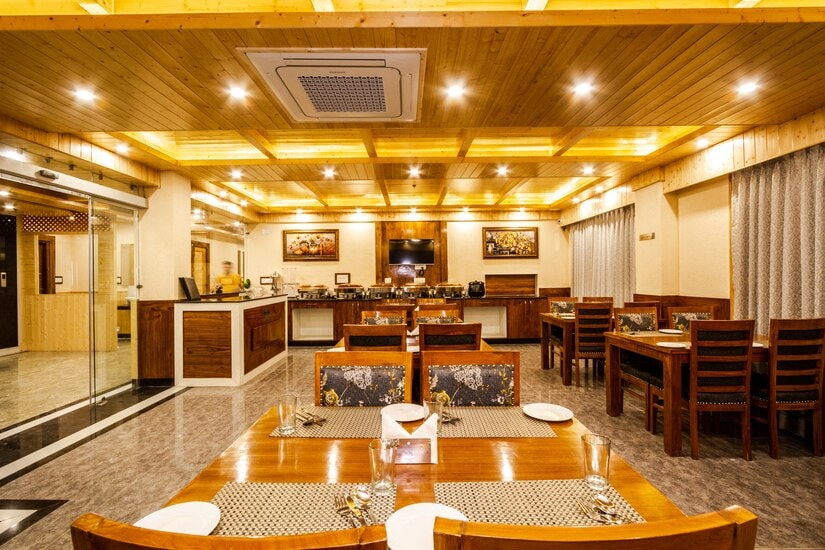Multi-cuisine restaurant interior at Hotel Suryansh Regency, Manali