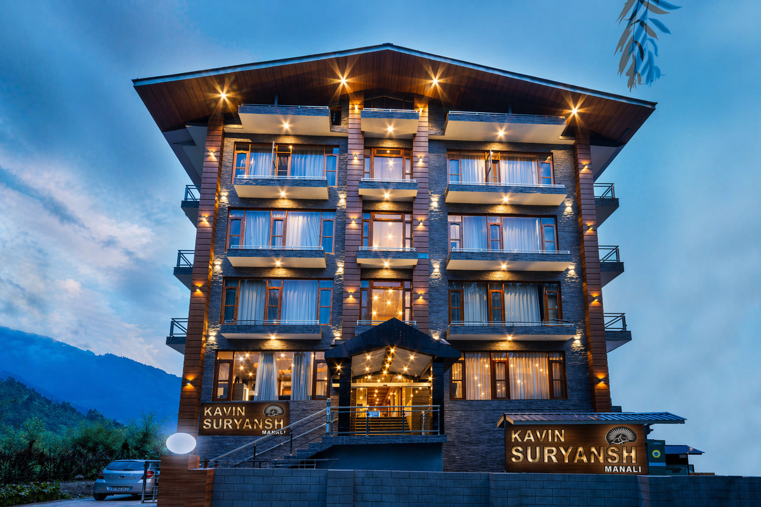 Hotel Suryansh Regency facade at dusk, Aleo, Manali, with mountain backdrop