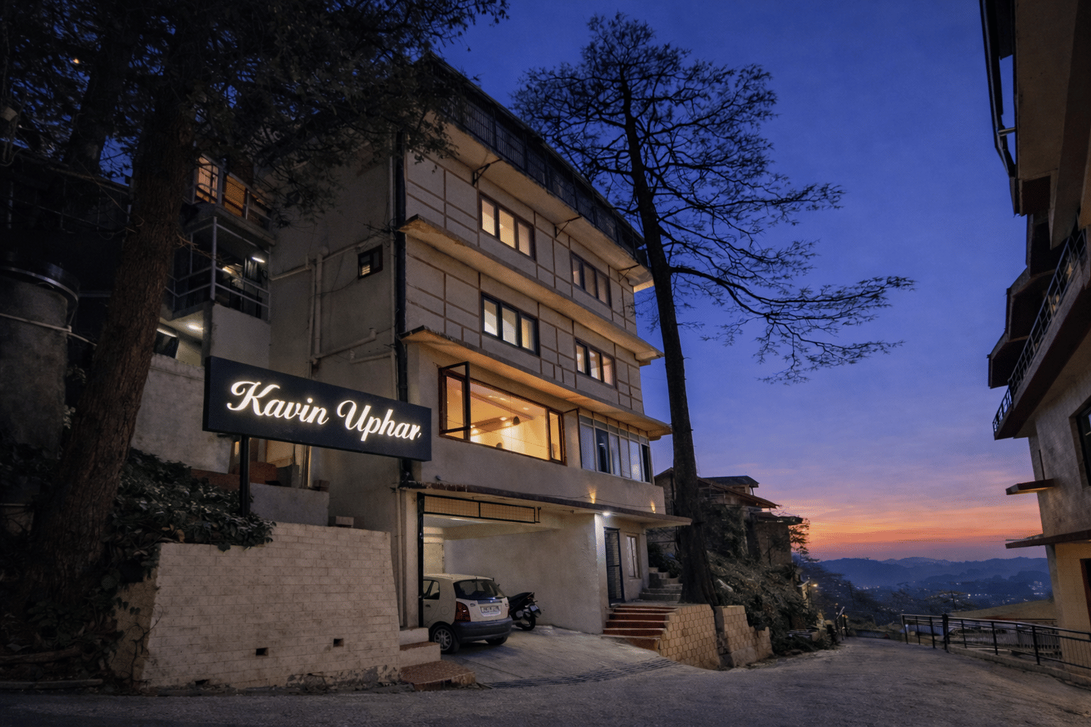 Kavin Uphar facade at blue hour with glowing signboard, Mall Road, Shimla