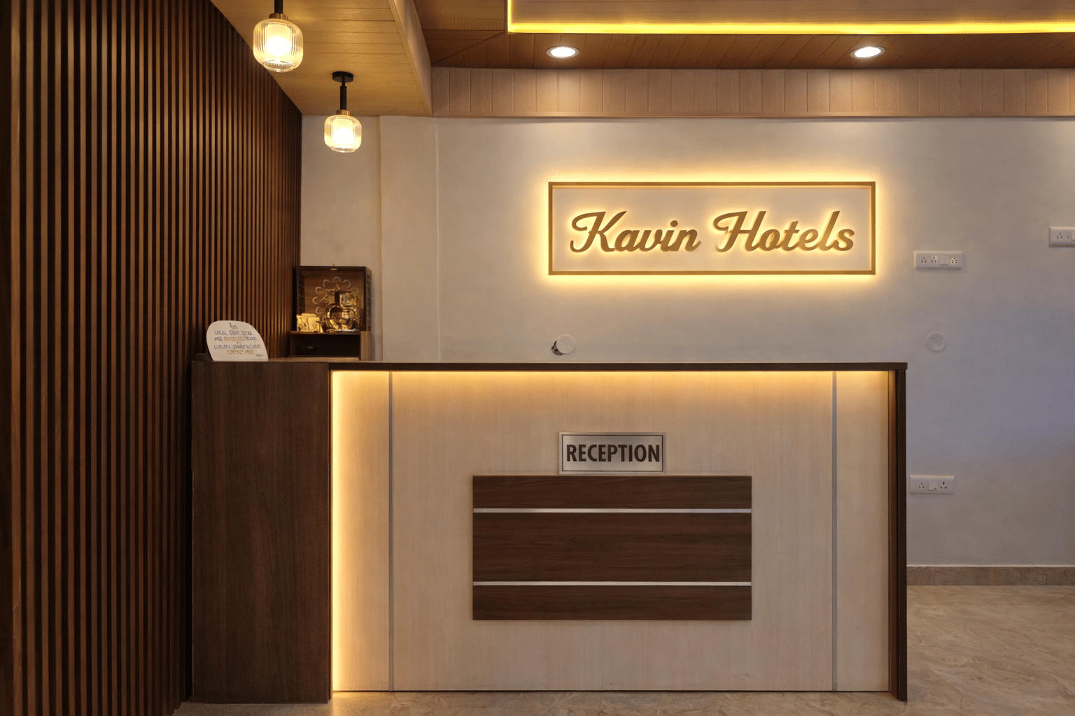Front-desk area with Kavin Hotels signage at Kavin Uphar - Near Mall Road