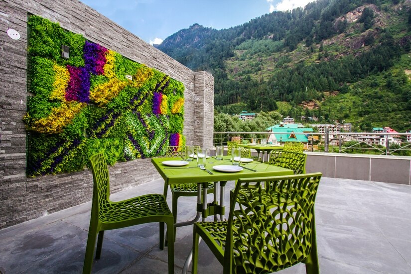 Open terrace dining with mountain view at Hotel Suryansh Regency By Kavin Hotels, Manali