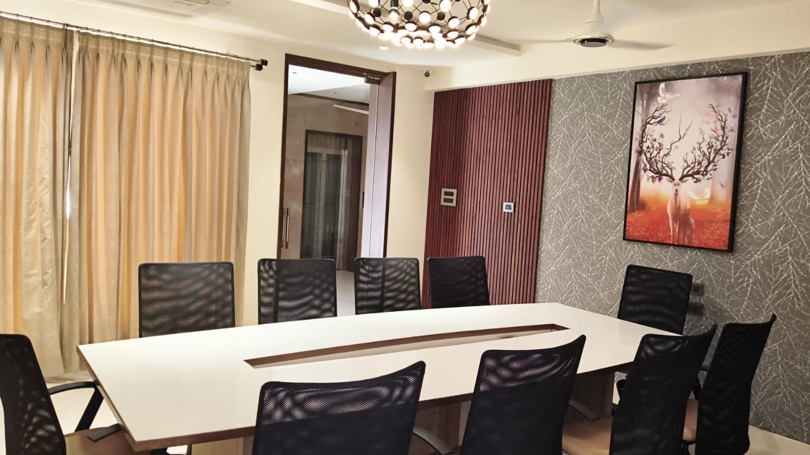 The air-conditioned Board Room arranged in a boardroom layout for focused meetings at Rossedale Suites & Hotel in Peelamedu, Coimbatore
