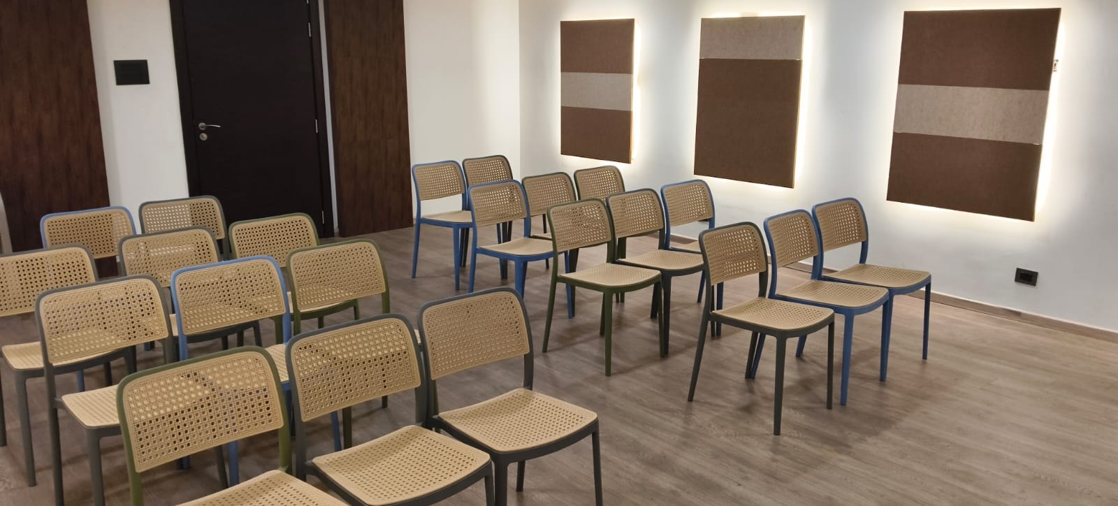 The air-conditioned banquet hall set theatre-style with cane chairs at Rossedale Suites & Hotel in Peelamedu, Coimbatore