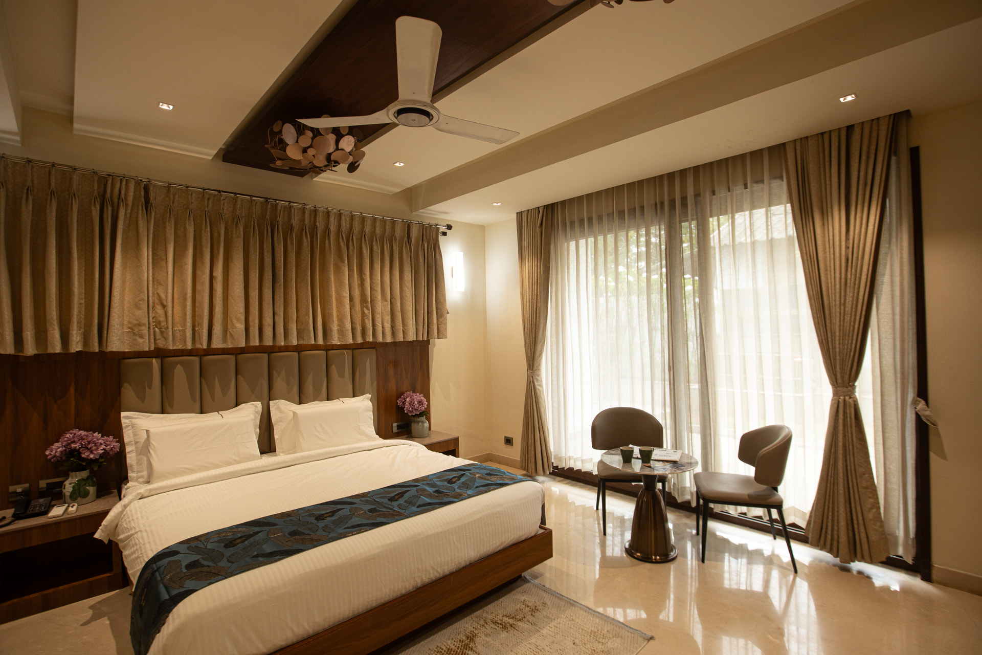 A neatly made king-size bed in the Executive Kitchenette at Rossedale Suites & Hotel in Peelamedu, Coimbatore