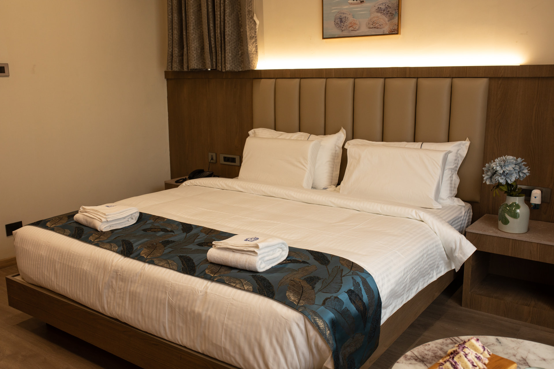 Crisp white bed linen and detailing in the Executive Room at Rossedale Suites & Hotel in Peelamedu, Coimbatore