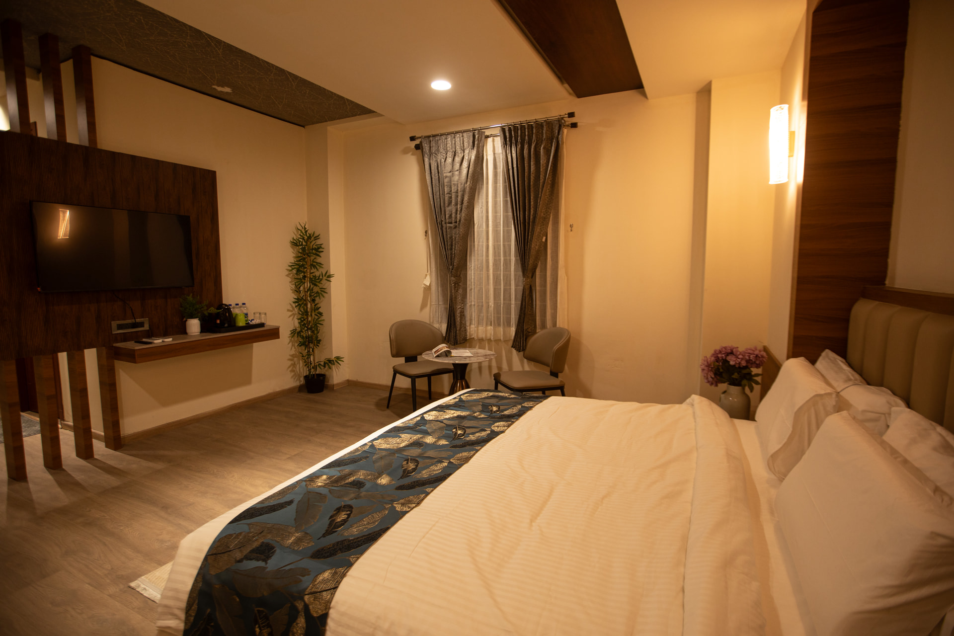 The Executive Room with a king-size bed and warm wood panelling at Rossedale Suites & Hotel in Peelamedu, Coimbatore