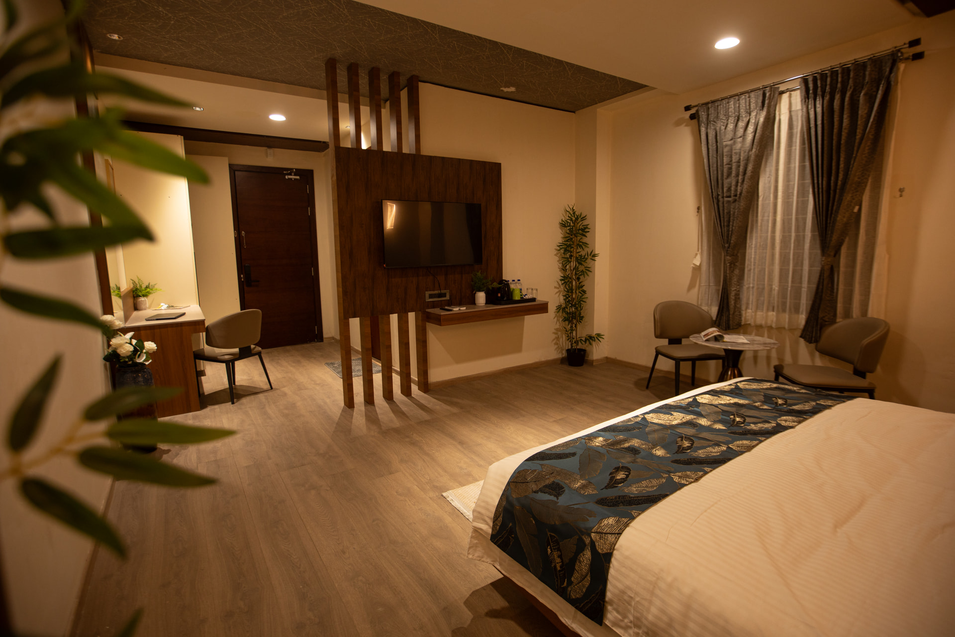 A neatly made king-size bed in the Executive Room at Rossedale Suites & Hotel in Peelamedu, Coimbatore