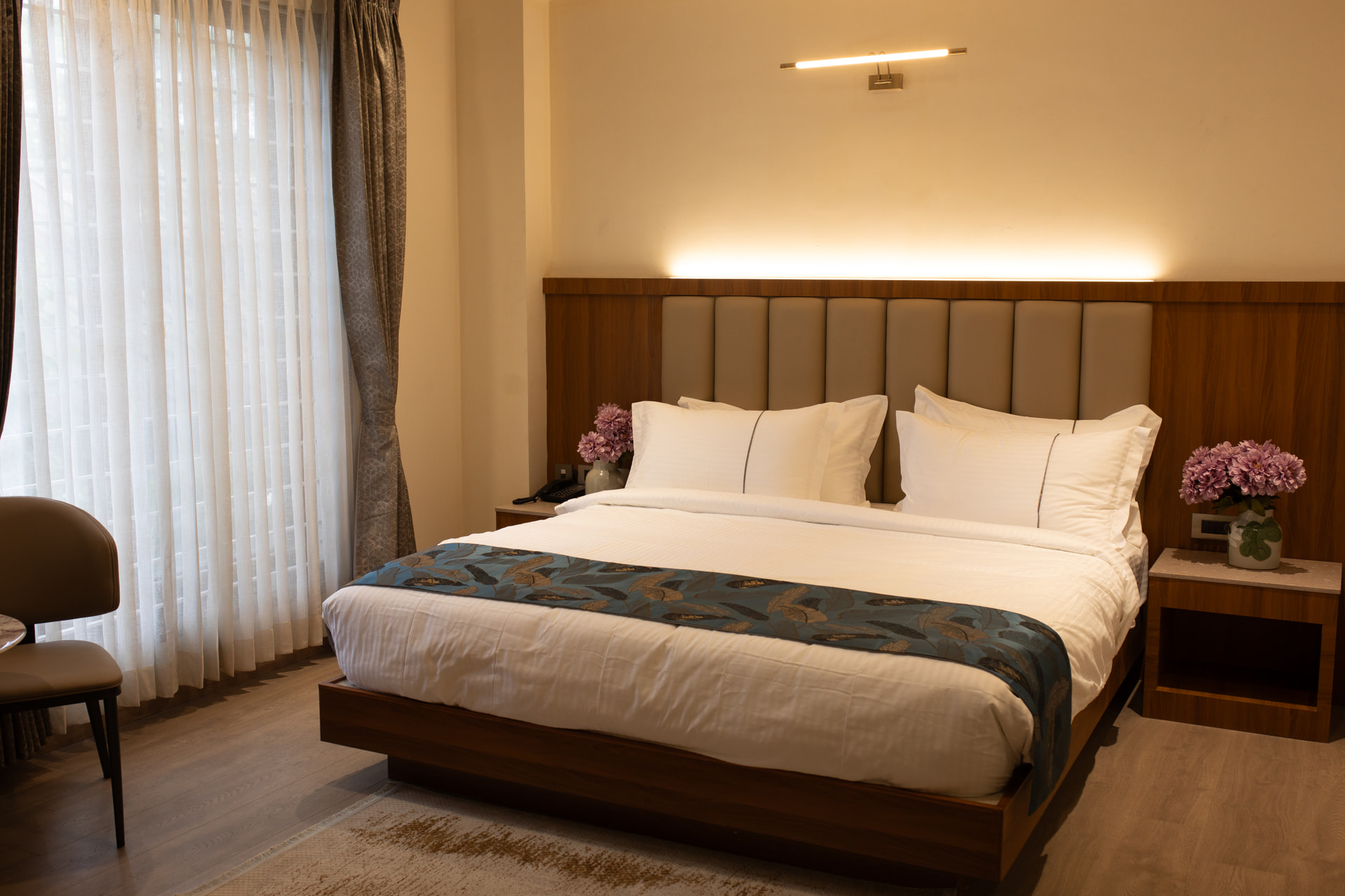 A king-size bed in the Family Suite at Rossedale Suites & Hotel in Peelamedu, Coimbatore