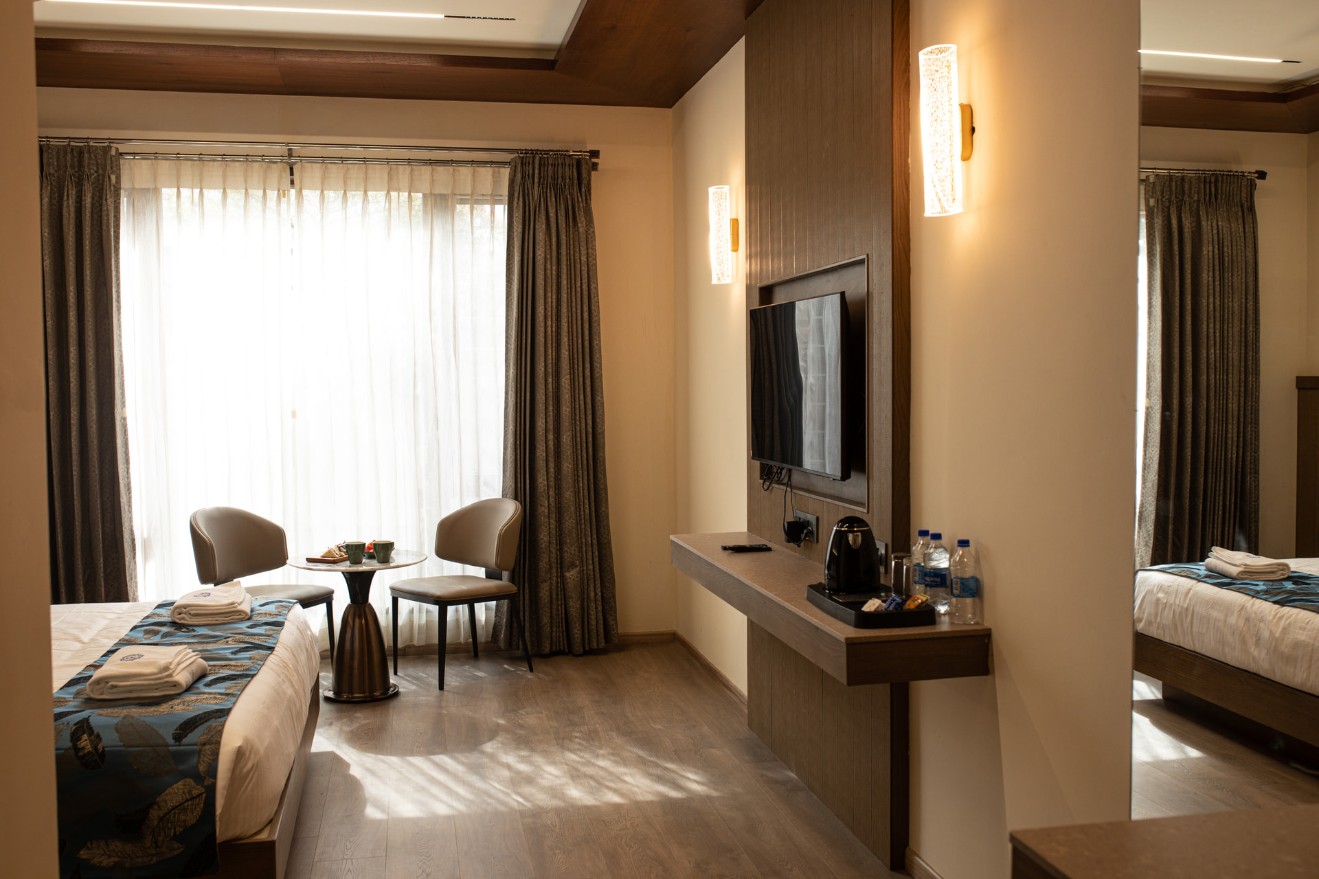 A seating area in the Family Suite bedroom at Rossedale Suites & Hotel in Peelamedu, Coimbatore
