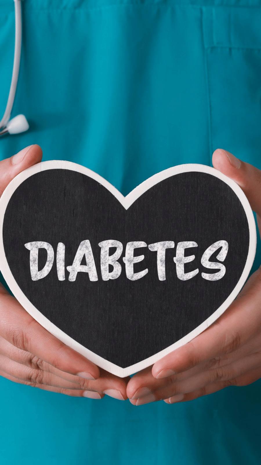 A person with a stethoscope holds a heart shaped object saying DIABETES